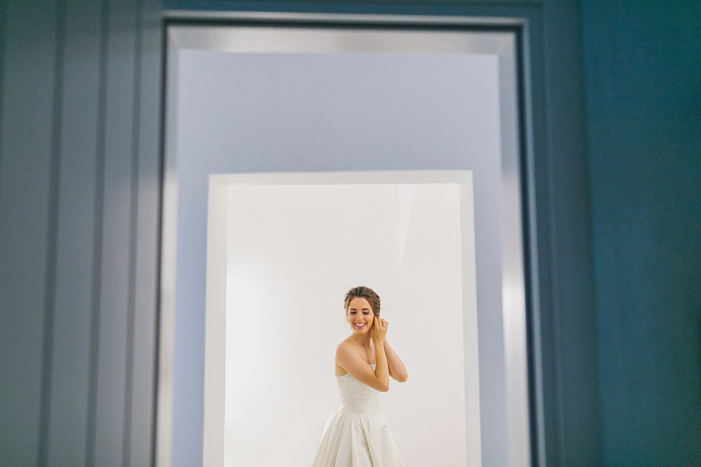 Santorini bride preparation, wearing earrings