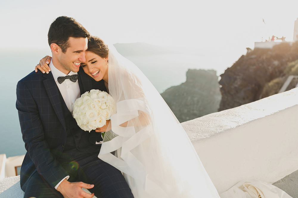 Santorini Imerovigli wedding photoshoot of bride and groom in happy love moments