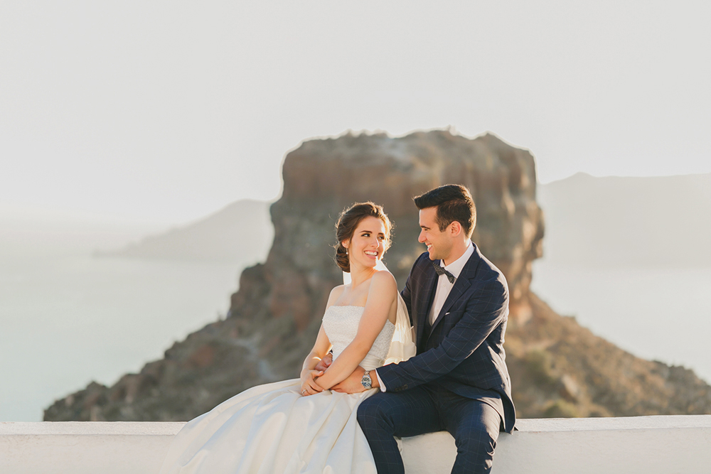 Santorini Imerovigli wedding photoshoot of bride and groom in happy love moments