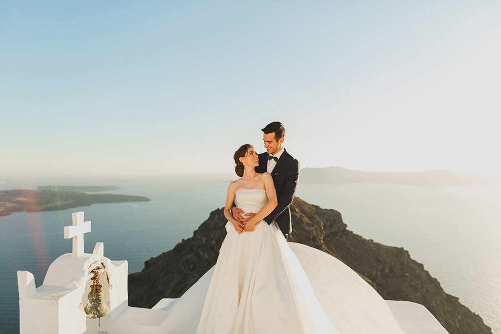 Santorini Imerovigli wedding photoshoot of bride and groom in happy love moments