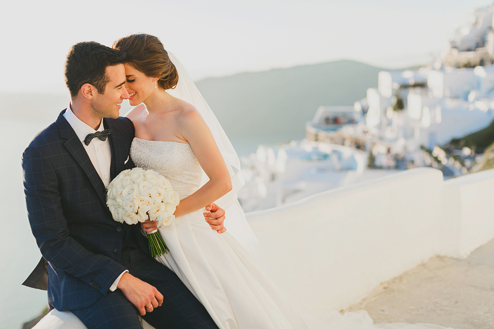 Santorini Imerovigli wedding photoshoot of bride and groom in happy love moments
