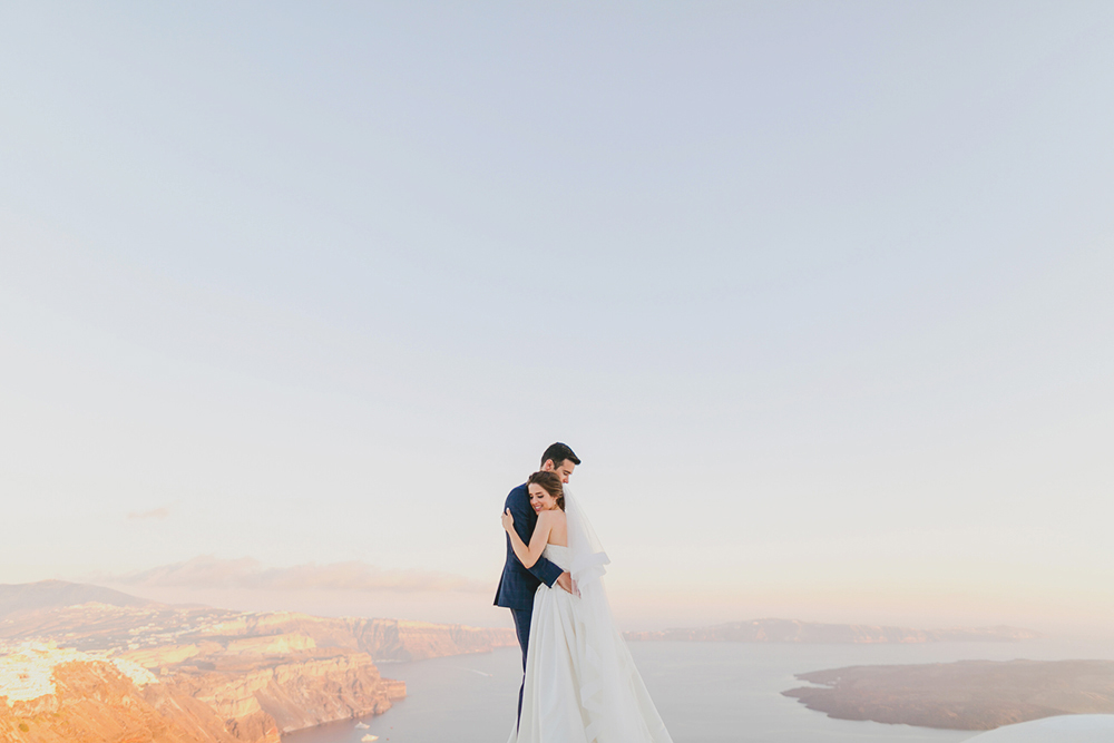 Santorini Imerovigli wedding photoshoot of bride and groom in happy love moments